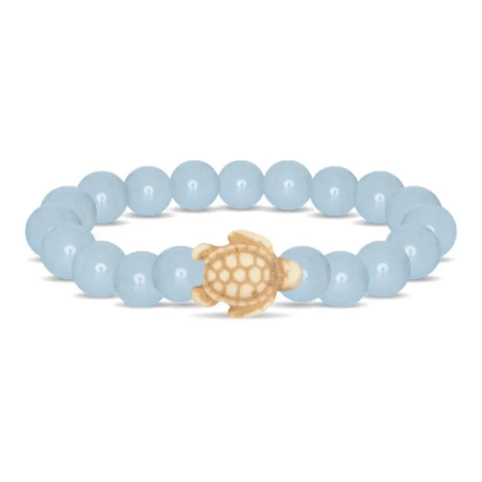 Fahlo Journey Aqua Glow Sea Turtle Bracelet featuring glow-in-the-dark aqua beads, engraved turtle charm, interactive real sea turtle tracking, and support for marine wildlife conservation.