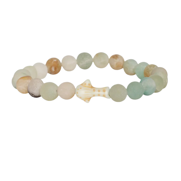 Multicolored Sky Stone beaded bracelet with a central shell-like charm shaped like a whale shark  on a white background