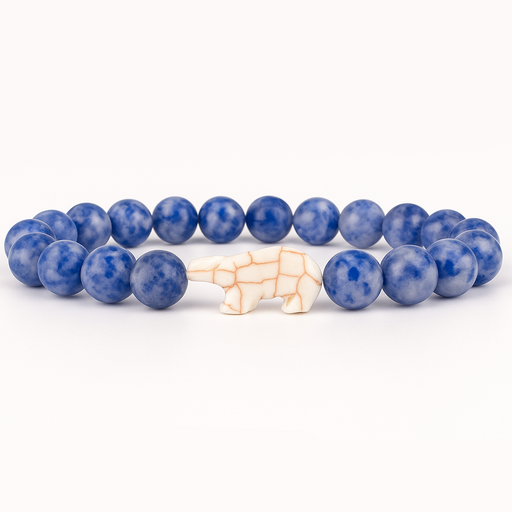 Blue beaded bracelet with a white Polar Bear  charm on a white background