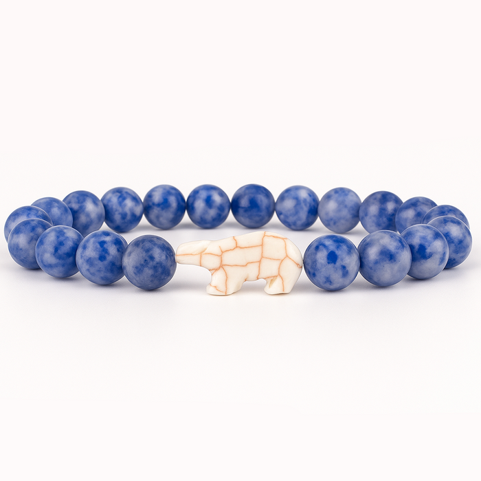 Blue beaded bracelet with a white Polar Bear  charm on a white background