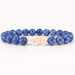 Blue beaded bracelet with a white Polar Bear  charm on a white background