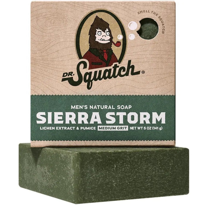 Dr. Squatch Sierra Storm men's natural soap on a stand with packaging in the background.
