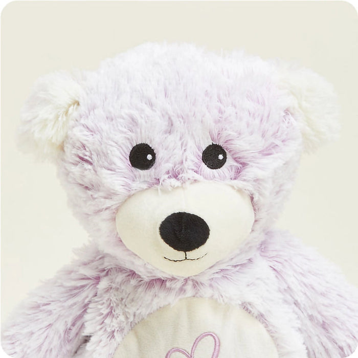 Close-up of Warmies Love Bear Plush face featuring soft pastel fur and friendly embroidered details