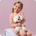 Child hugging a Warmies Puppy Plush microwavable stuffed animal for comfort and warmth