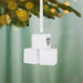 White baby blocks ornament with 'Grandparents' Best Christmas' text on a blurred green background