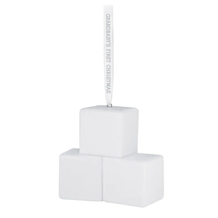 White baby blocks with 'Grandbaby's First Christmas' ribbon on a white background