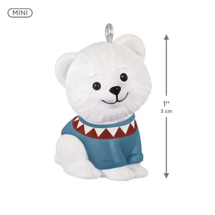 White polar bear figurine with a blue sweater and red trim, featuring measurements on a white background.