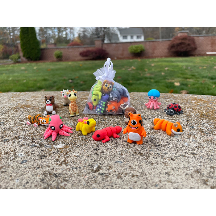 Colorful Wiggletz and bag set on a concrete surface with a grassy area and trees in the background