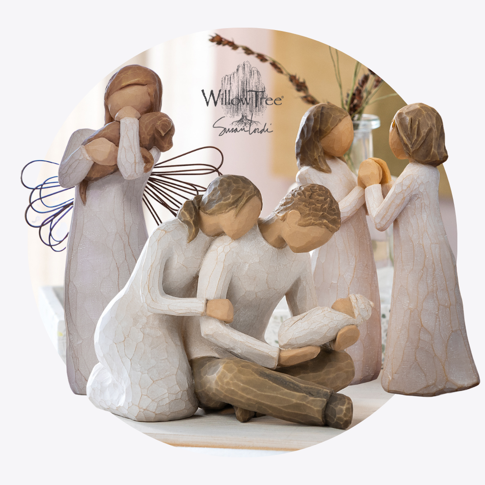 Willow Tree figurine of a family scene with a mother, father, and two children on a white background.