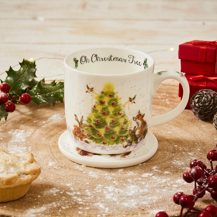 Wrendale Designs Oh Christmas Tree festive mug on coaster surrounded by holly, gifts and Christmas décor.