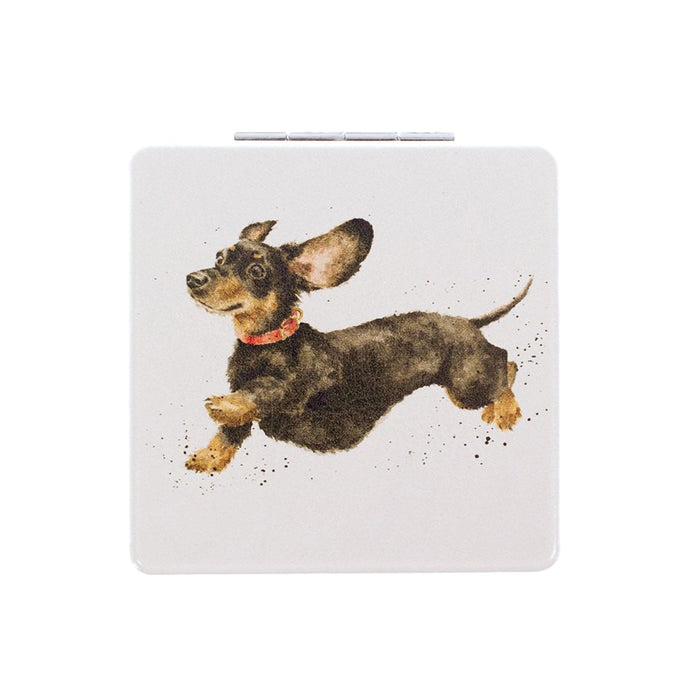 Wrendale Designs 'That Friday Feeling' dachshund compact mirror with illustration of a black and tan dachshund leaping joyfully.