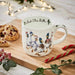 Wrendale Designs Duck The Halls Mug on holiday table with cookies and decorations.