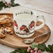 Rockin’ Robins mug featuring three illustrated robins displayed on a wooden tray with cookies and greenery.