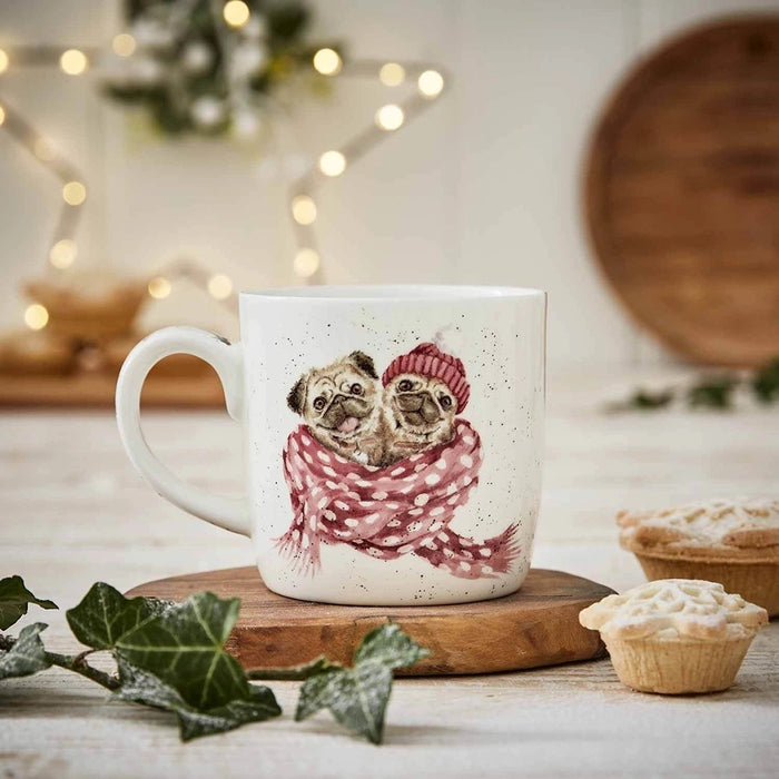 Lifestyle photo of Snug as a Pug Mug featuring two pugs wrapped in a scarf