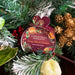 Packaged Christmas wreath soap with festive decorations in the background