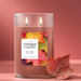 Unlit large Yankee Candle Autumn Leaves tumbler with two wicks and a silver lid, showing a label decorated with colorful fall leaves.