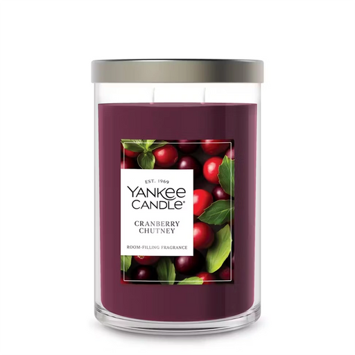 Yankee Candle Cranberry Chutney candle with cranberries and leaves on a white background