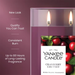Yankee Candle Cranberry Chutney candle with product features on a purple background