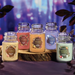 Fall Collection of Yankee Candle Original Jars on a wooden log with a blurred purple background