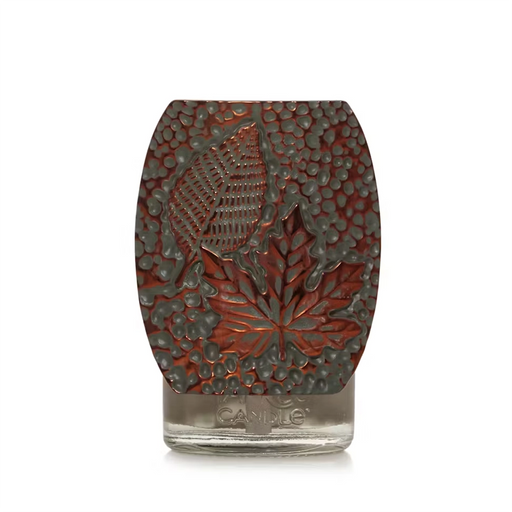Close-up of the Yankee Candle Autumn Leaves Plug-In Diffuser with embossed leaf design in bronze and copper finish.