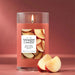 Yankee Candle Sugared Cinnamon Apple candle with apples on a red background