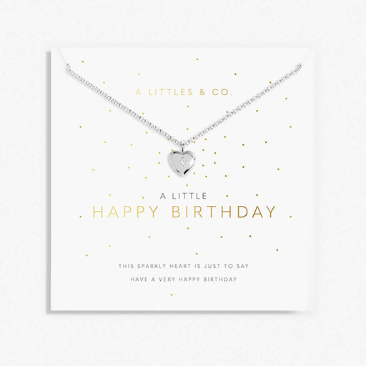 Silver heart necklace on a 'Happy Birthday' card with gold text