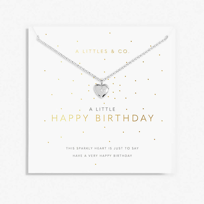 Silver heart necklace on a 'Happy Birthday' card with gold text