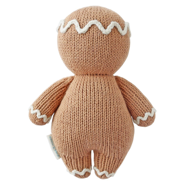Back view of Cuddle + Kind Baby Gingerbread Doll – handmade knit stuffed toy with icing detail trim.