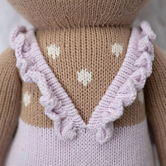 Close-up of the back of the deer doll’s lavender romper, showing ruffled straps and white knitted spots.