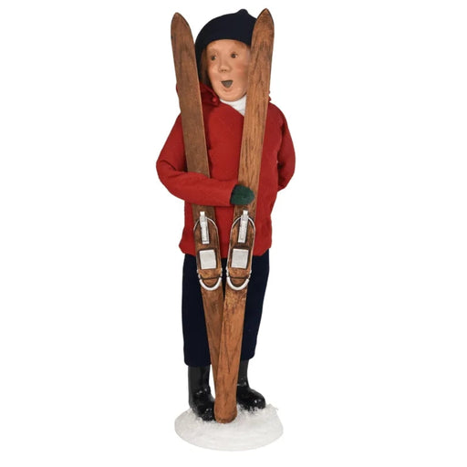 Decorative Byer's  figurine of a man in winter attire with skis on a white background