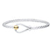 Silver bracelet with a gold clasp on a white background