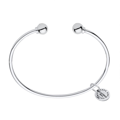 Silver bracelet with a round clasp and a tag on a white background