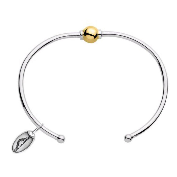 Silver bracelet with a gold bead on a white background