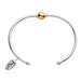 Silver bracelet with a gold bead on a white background