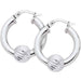 Silver hoop earrings with ball accents on a white background