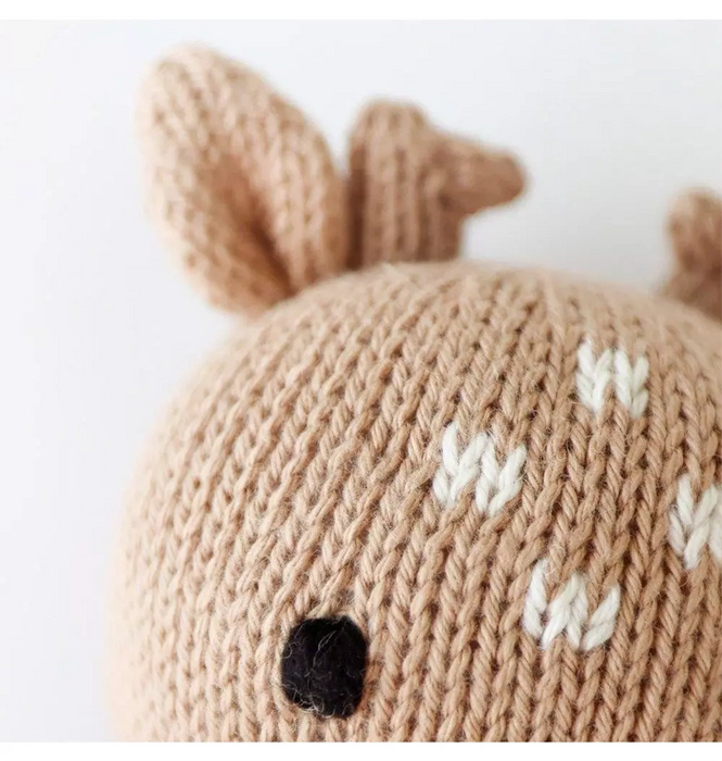 Close-up of Cuddle + Kind Baby Fawn knit detail – embroidered eye and white spotted forehead.