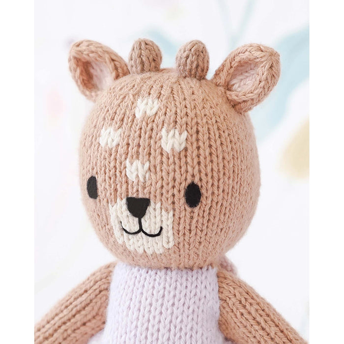 Close-up of Cuddle + Kind Tiny Violet the Fawn doll showing hand-knit details and embroidered smile.