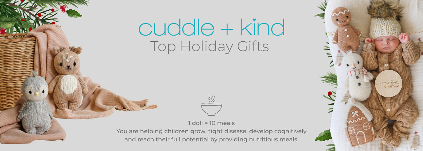 Cuddle + Kind holiday gift set with toys and a basket on a light background