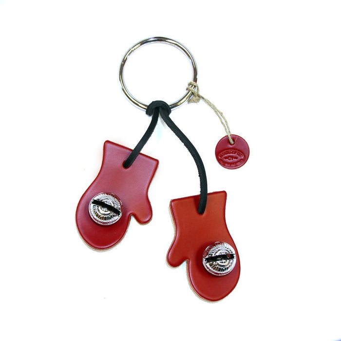 Red mitten-shaped keychain with a black cord on a white background