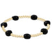 enewton design bracelet with gold beads and black stones on a white background