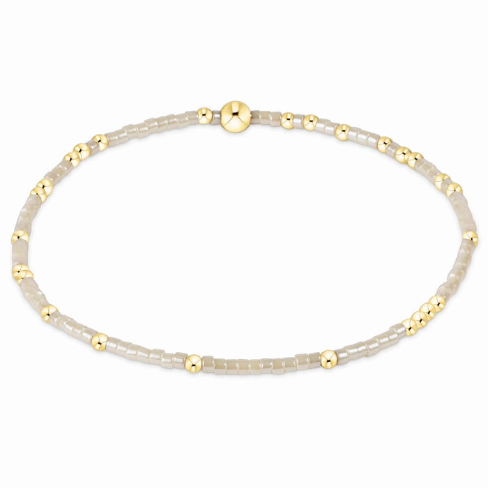 enewton design Hope Unwritten Bracelet featuring milkshake seed beads with 14k gold-filled accents displayed in a circular layout on a white background.