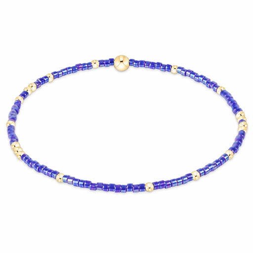 enewton design Hope Unwritten Bracelet featuring blue metallic seed beads with 14k gold-filled accents displayed in a circular layout on a white background.