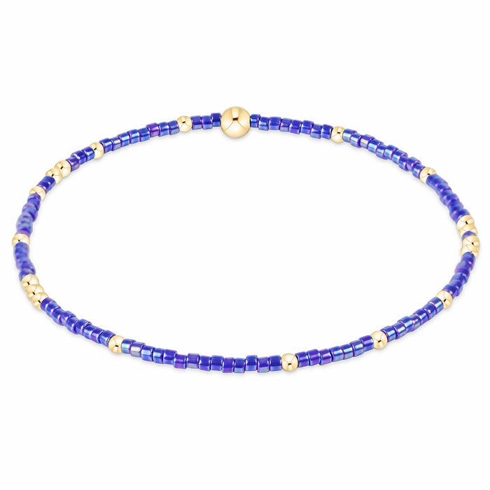 enewton design Hope Unwritten Bracelet featuring blue metallic seed beads with 14k gold-filled accents displayed in a circular layout on a white background.