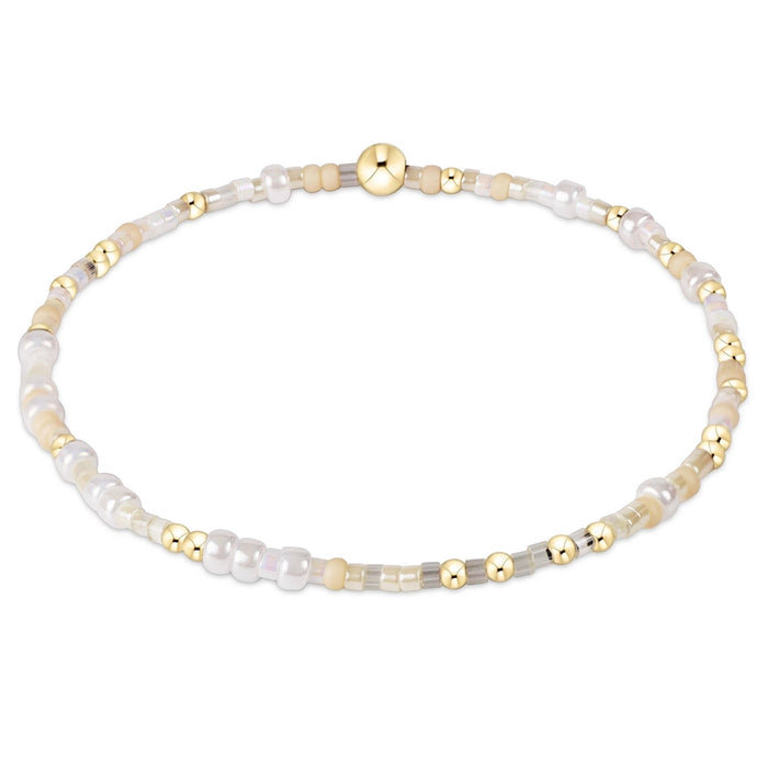enewton design Hope Unwritten Bracelet featuring Snow color seed beads with 14k gold-filled accents displayed in a circular layout on a white background.