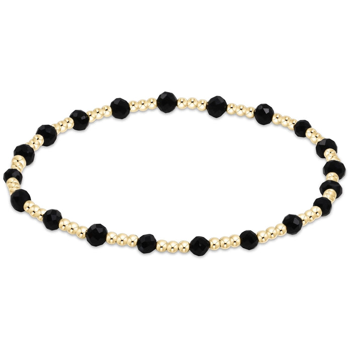 enewton Sincerity Pattern Bead Bracelet with faceted black onyx beads and 14k gold-filled beads arranged in a repeating pattern on a stretch band.