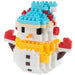 A small snowman toy built from tiny interlocking blocks, with a light blue hat, red gloves, yellow scarf, and white body, shown on a plain white background.