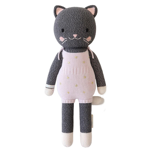 Hand-knit Cuddle + Kind Nova the Kitten doll in gray with pink overalls decorated with gold stars, fair trade and heirloom quality toy.