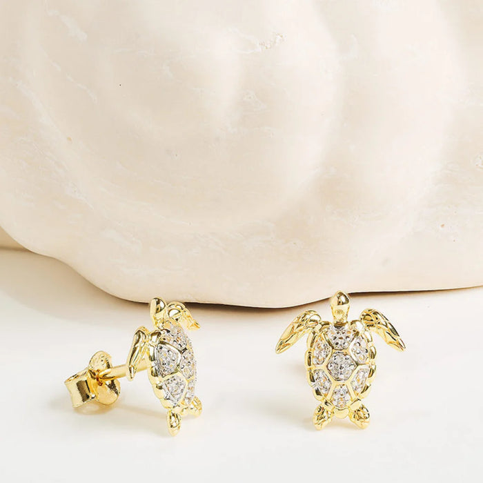 White Sapphire Turtle Earrings on a light background