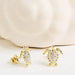 White Sapphire Turtle Earrings on a light background