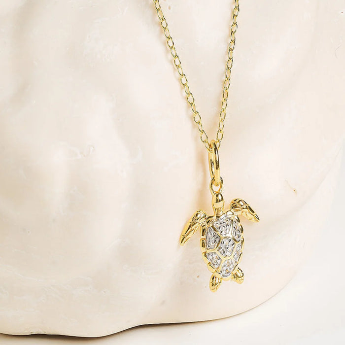 White Sapphire Turtle Necklace in a light background